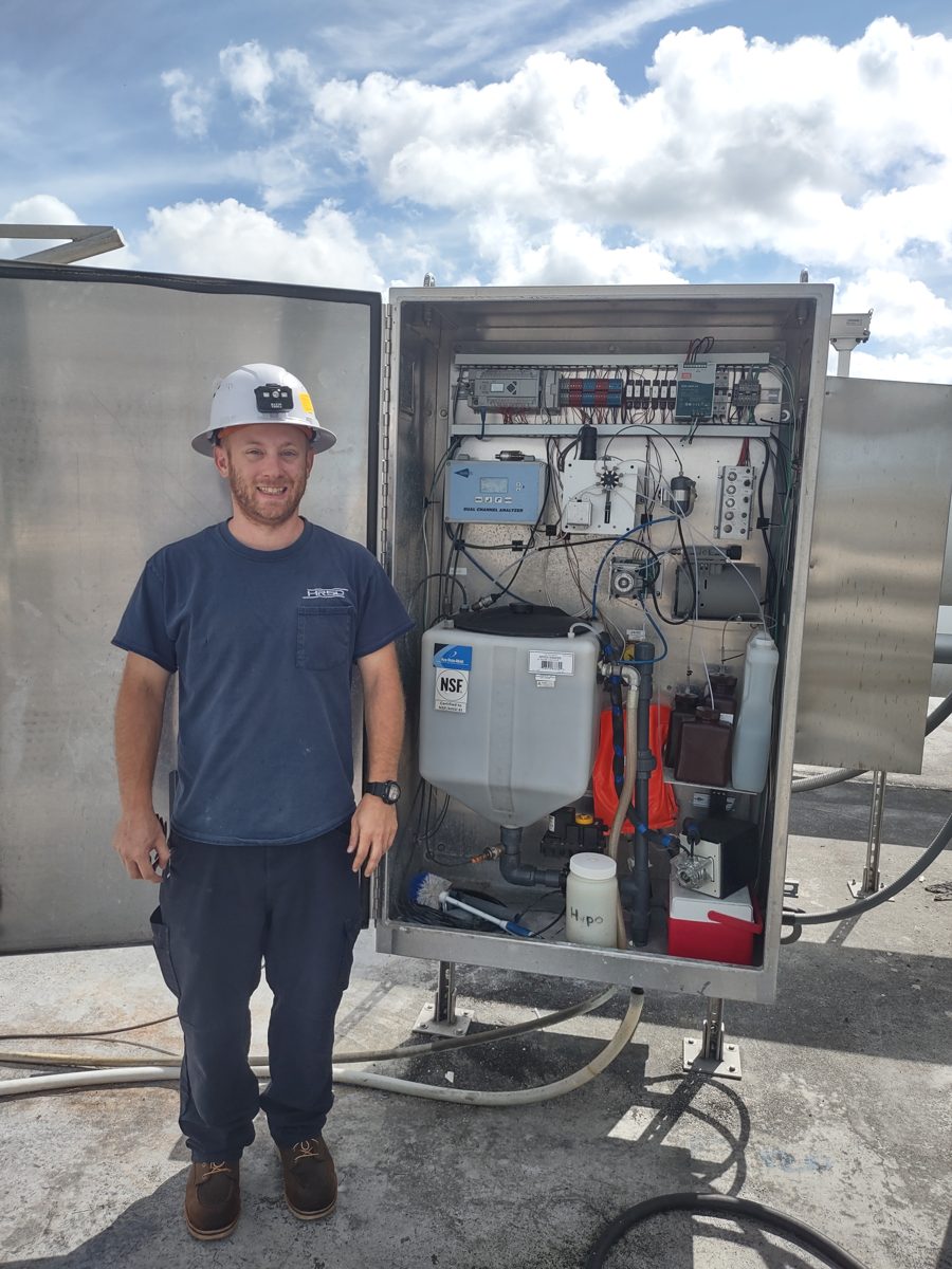 An HRSD operator beside an open Jarbalyzer cabinet at a treatment plant